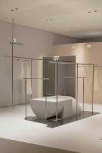 A modern retail shop with white concrete and metal elements.