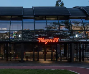 Modern storefront with metal, glass, and neon signage