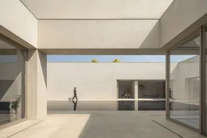 A modern interior space with concrete walls and flooring, featuring a minimalist design.