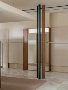 Modern minimalist interior design featuring wooden walls, glass doors, marble flooring, and fabric upholstery.
