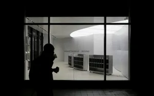 A minimalist retail space with a modern, sleek design featuring white lighting and white surfaces.