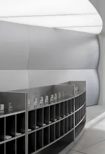 A sleek, modern retail storefront featuring a minimalist design and metallic shelving units.