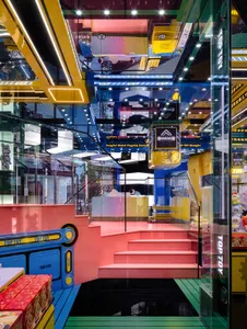 A vibrant and colorful retail store interior with plastic structures and stairs.