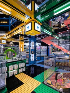 Colorful toy shop with bright lights, metal fixtures, and various toys displayed on shelves.