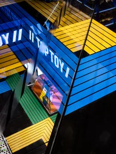 A minimalist retail storefront with glass features and blue signage.