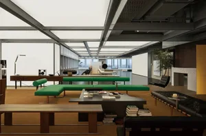 Industrial-style office space with concrete floors, wooden tables, and glass partitions.