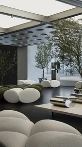 Modern minimalist lobby featuring white and green beanbag-style seating.