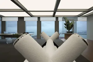 Modern office space featuring a desk with white towels and an open-plan design with large windows overlooking the cityscape.