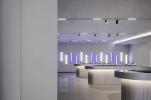 A modern reception counter with metallic and concrete finishes.