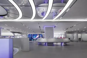 A modern scientific exhibit space featuring metallic and glass materials with lights.