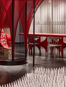 Modern, industrial-style restaurant interior with metallic walls and tables