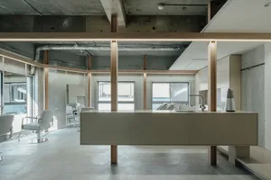 Modern Art-Deco coffee shop interior featuring concrete, steel, and minimalist design elements.