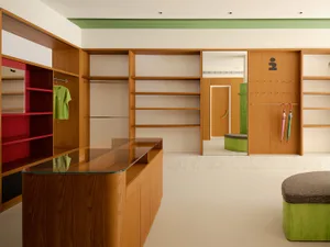 Modern closet area with open shelving and a wood finish