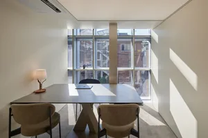 Modern office space featuring minimalist furniture and contemporary design elements.