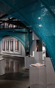 A modern retail display featuring a unique netting structure made of metal panels.