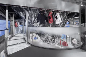 A retail interior showcasing a display of outerwear clothing.