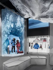 Retail storefront featuring mannequins dressed in cold-weather apparel standing in a simulated ice cave.