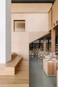 A minimalist library with wooden walls and shelves