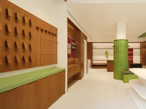 Modern retail interior featuring wooden shelving units and clothing racks