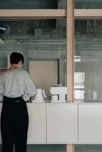 A minimalist kitchen counter featuring white appliances and a sleek design.