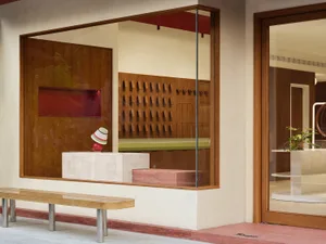 A modern storefront with a metallic display inside, showcasing retail products.
