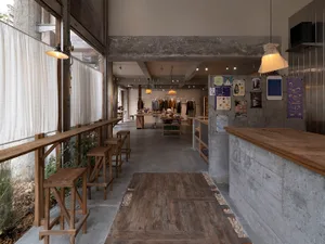 An industrial-style coffee shop with concrete materials and an open layout.