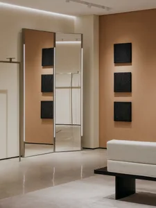 Minimalist interior design featuring metal and concrete furniture in a retail environment.