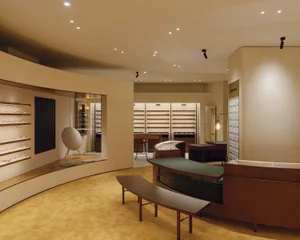 A modern retail store interior with wooden shelves and displays.