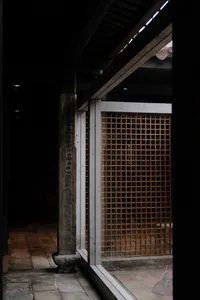 Concrete doorway with a wooden lattice window in an ancient structure