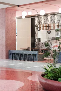 Modern cafe interior featuring terrazzo, marble, and concrete materials
