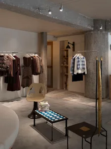 A clothing store with industrial design featuring concrete walls, minimalist furniture, and clothing racks.