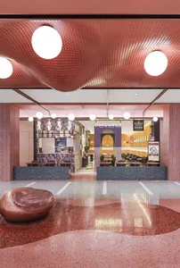 Modern restaurant interior with marble, terrazzo, and metallic accents