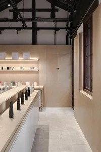A modern retail store featuring wooden shelves and a minimalist design.