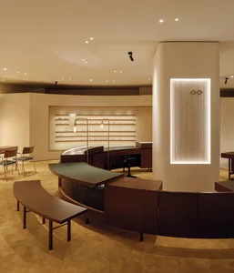 A minimalist retail store with concrete and wood finishes and a glass front window.