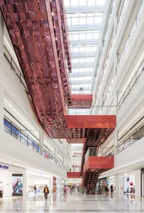 A shopping center interior with modern design elements including glass and metal.