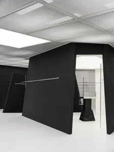 An interior space with black walls and metallic accents.