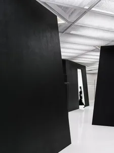 A minimalist black interior space with clean lines and a sleek design.