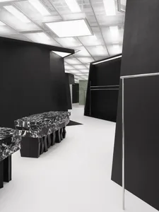 A minimalist retail storefront featuring black marble accents.