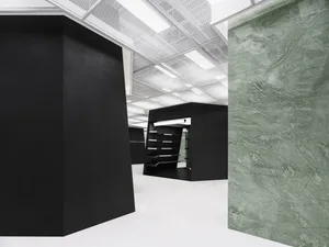 An office space featuring modern design with concrete and glass materials.