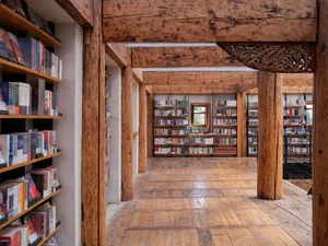 A wooden library with bookshelves filled with books.