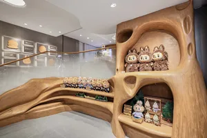 A wooden store display featuring plush toys and memorabilia.