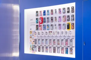 A variety of colorful, artistic iPhone cases displayed on a blue background with a white card containing information about th