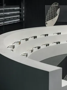 A concrete display featuring multiple pairs of sunglasses in a retail or showroom setting.