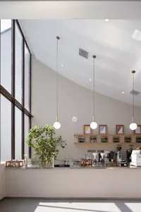 A minimalistic coffee shop interior featuring modern materials and ample natural lighting.
