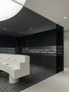 Modern retail storefront with minimalist design featuring a concrete floor and walls.