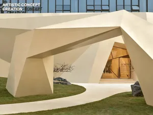 A modern, geometric concrete entrance with angular shapes and smooth surfaces.