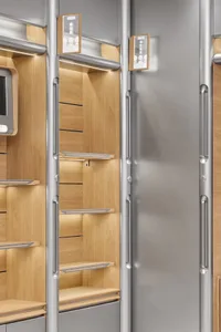 A modern retail display with wooden shelves and metallic rails and handles.