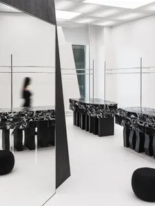 A modern retail storefront featuring black marble surfaces and minimalist design.