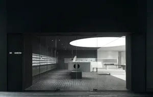 A modern retail space featuring glass, metal, and concrete materials.