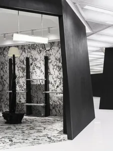 A modern retail storefront featuring a combination of concrete and marble materials.